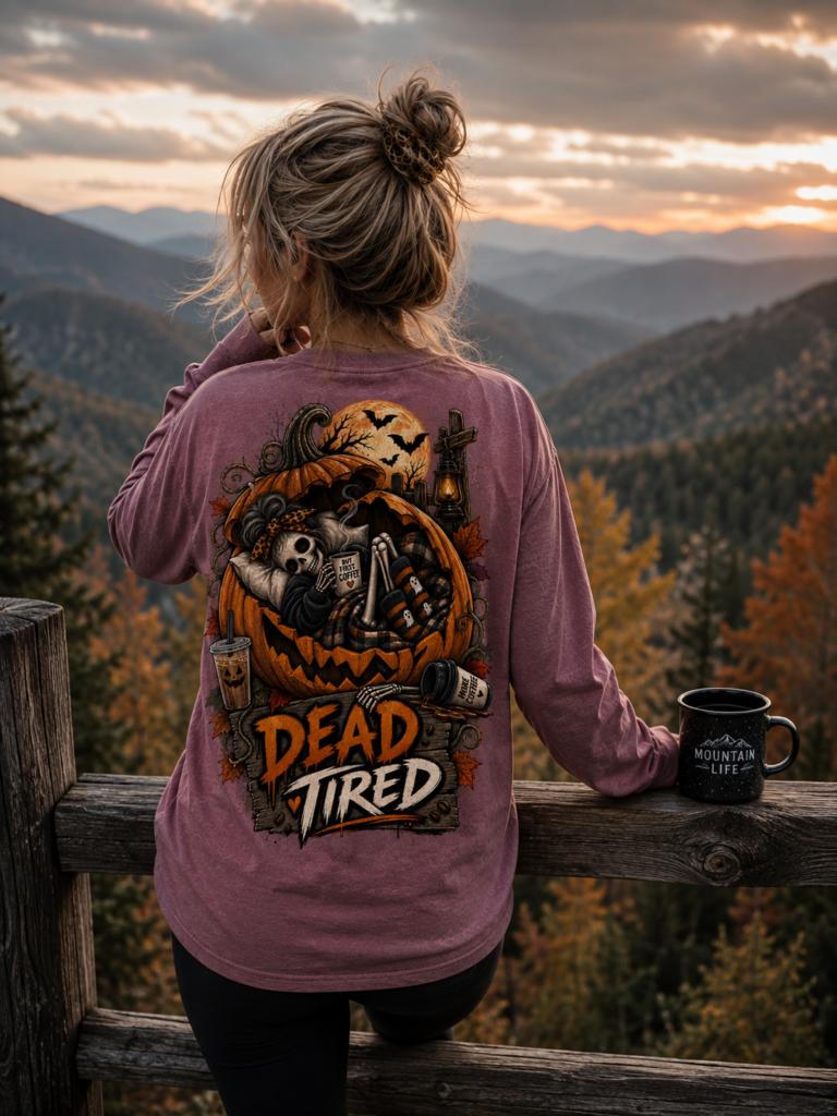 Dead Tired Halloween long sleeve shirt featuring a skeleton relaxing inside a pumpkin with coffee, autumn leaves, bats, lantern details, and Hunniford Acres logo on the front chest.